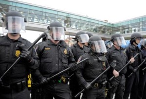 Police dressed in riot gear hold their line on Pratt Street near Howard in Baltimore on Saturday, April 25, 2015, as protests continue in the wake of Freddie Gray's death while in police custody.