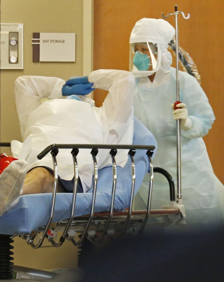 A patient transported from Frisco, Texas, with concerns of possible exposure to Ebola, arrives at Texas Health Presbyterian Hospital in Dallas on Wednesday, Oct. 8, 2014. (Louis DeLuca/Dallas Morning News/MCT)