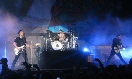  Blink-182 performing at the Valley View Casino Center in San Diego, California on December 11, 2011 as part of radio station 91Xs Wrex the Halls concert. Left to right: singer/bassist Mark Hoppus, drummer Travis Barker, and singer/guitarist Tom DeLonge.