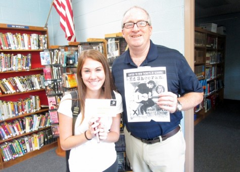 Amanda Martini was the lucky winner of the Green Wave Gazette Ticket Raffle. She won two  tickets to see Ed Sheeran perform at Gillette Stadium. Here she is accepting her tickets from GWG adviser, Mr. Dorman