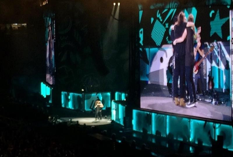 The boys sharing a group hug after singing happy birthday to Niall with the crowd.