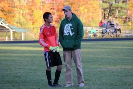 Coach McGinness talks things over with senior goalie Gregory Oreste