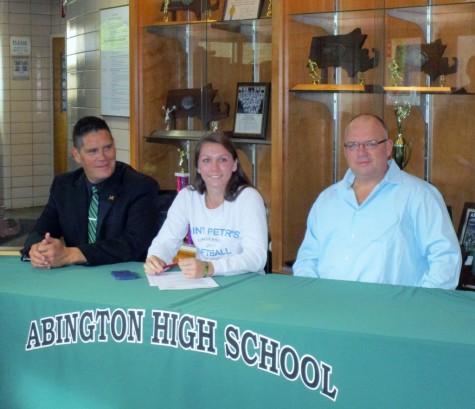 Katie Donovan signs her letter of intent to St. Pauls University with Abington coach Ernie Ortega to her right and her father John Donovan to her left.