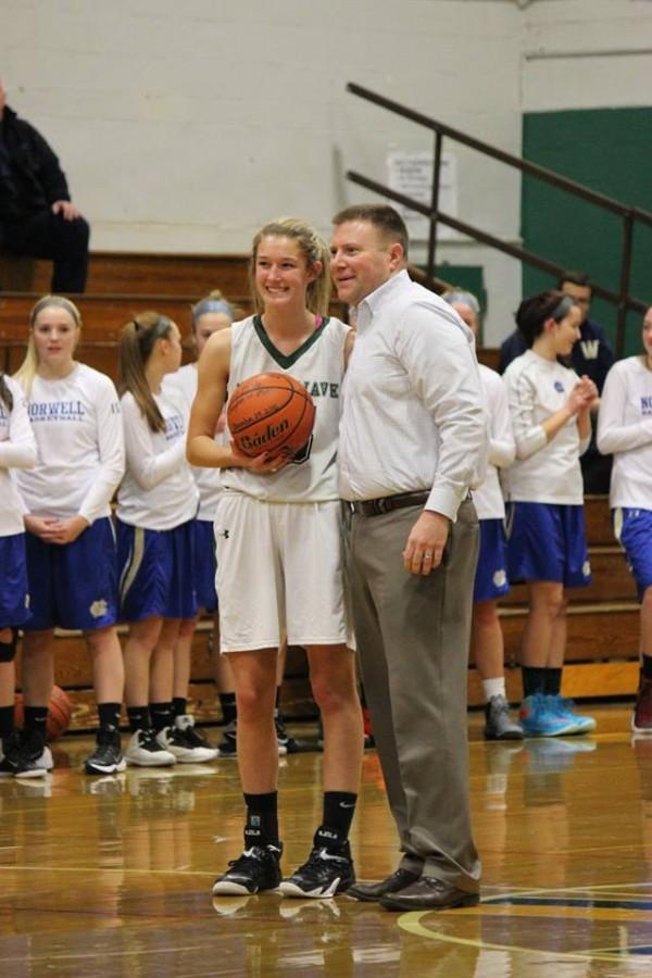 Coach Moore congratulates Jenny Worden for scoring her 1,000th point.