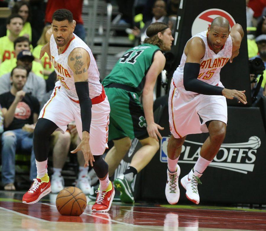 The Atlanta Hawks Thabo Sefolosha, left, steals the ball from the Boston Celtics Kelly Olynyk while Al Horford follows on the fast break during the first half in the Eastern Conference quarterfinals at Philips Arena in Atlanta on Saturday, April 16, 2016. (Curtis Compton/Atlanta Journal-Constitution/TNS)