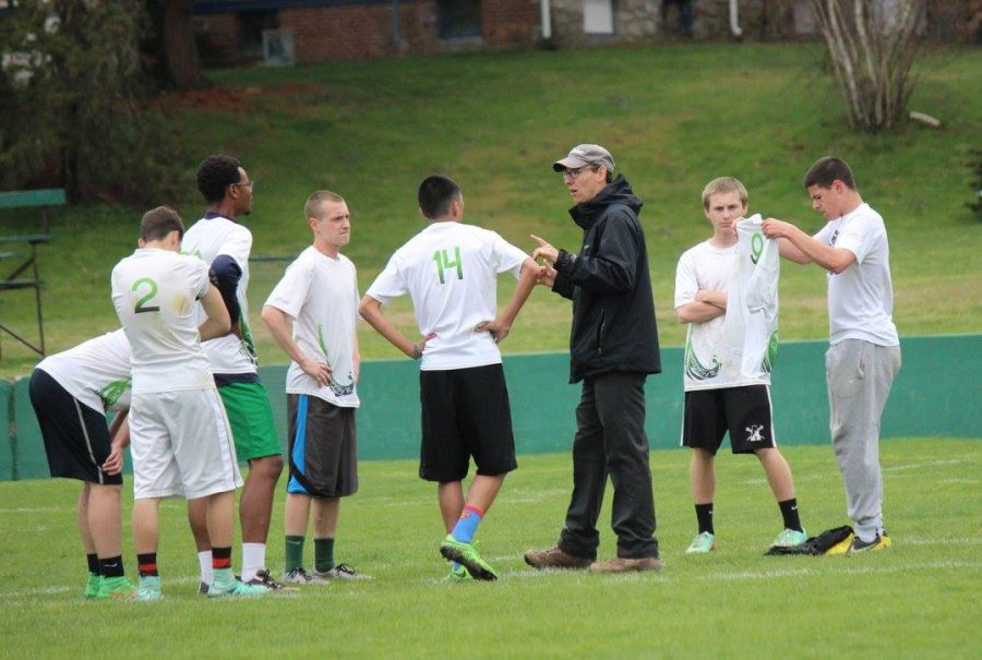 Coach Scott discusses strategy with the team. (Debra Herron Quinn courtesy of the Green Wave Boosters)