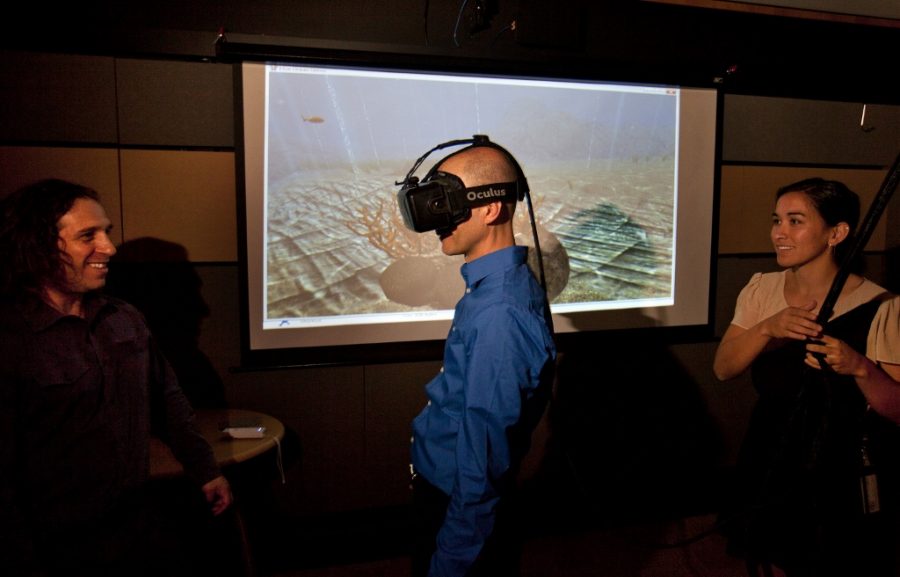San Jose Mercury News reporter Troy Wolverton uses an Oculus Rift virtual reality system as founding director Jeremy Bailenson, left, and researcher Elise Ogle look on at Stanford Universitys Virtual Human Interaction Lab in Palo Alto, Calif., on June 24, 2015. Consumers will have their pick of four high-profile virtual systems from major electronics companies, including Facebooks Oculus Rift. (Patrick Tehan/Bay Area News Group/TNS)