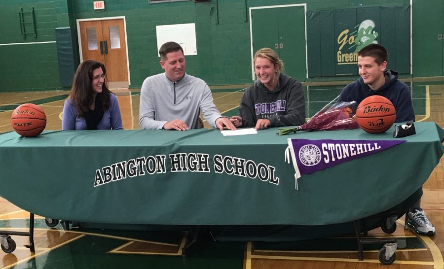 Jenny signs her letter of intent with her family by her side.
