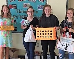 Ms. Gerhart, Advisor of Student Council, and Green Wave Gazette members Kathryn Genest,  Arianna Akusis, and Abby Joyce, all freshmen, pose with some of the items collected this month during a fundraiser for the pets displaced in Houston due as a result of Hurricane Harvey 
 that hit in early September 