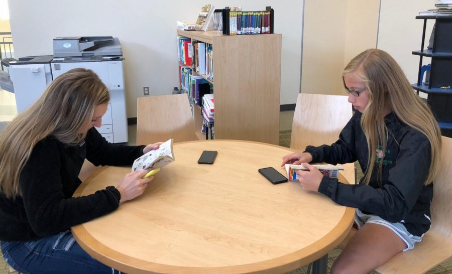 Freshmen Brooke Barry and Kaylee Carver Reading in the AHS Library