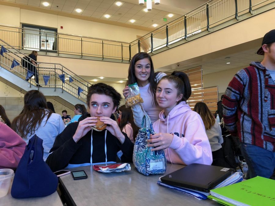 Jason Dole 21 enjoying cafeteria lunch, alongside classmates Lyla Blanchard and Aleena Magnasco 