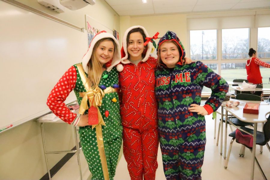 Juniors Kerry Cardinal, Izzy Miele, and Mikayla Littman decked out in festive onesies on Friday before the winter break.