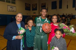 Senior Bryson Andrews celebrates after scoring his 1,000th point on Tuesday, January 29, 2019, against the Hull Pirates. Standing with Andrews (left to right) is his grandmother Margaret Andrews, aunt Gold Andrews, Bryson Andrews, mother Lillian Brice, and sister Savannah Brice.