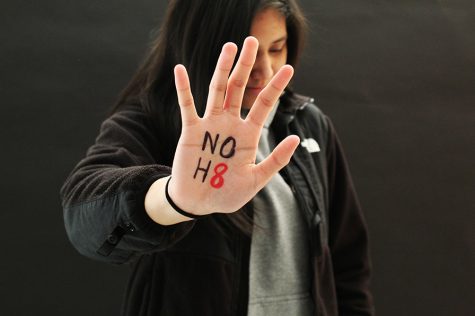 No H8 (hate). Erielle Amboy, a junior student-athlete at Abington High School, raises her hand to stand against hate. Like many students and young people around the nation, students in Abington are taking a stand against bullying, hatred, and prejudice.