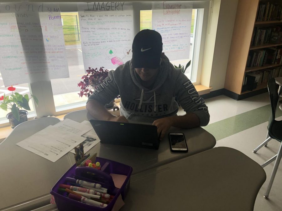 Abington High School junior Joao Carlos Andrade works on his essay in Journalism/Media class on October 18, 2019. 
