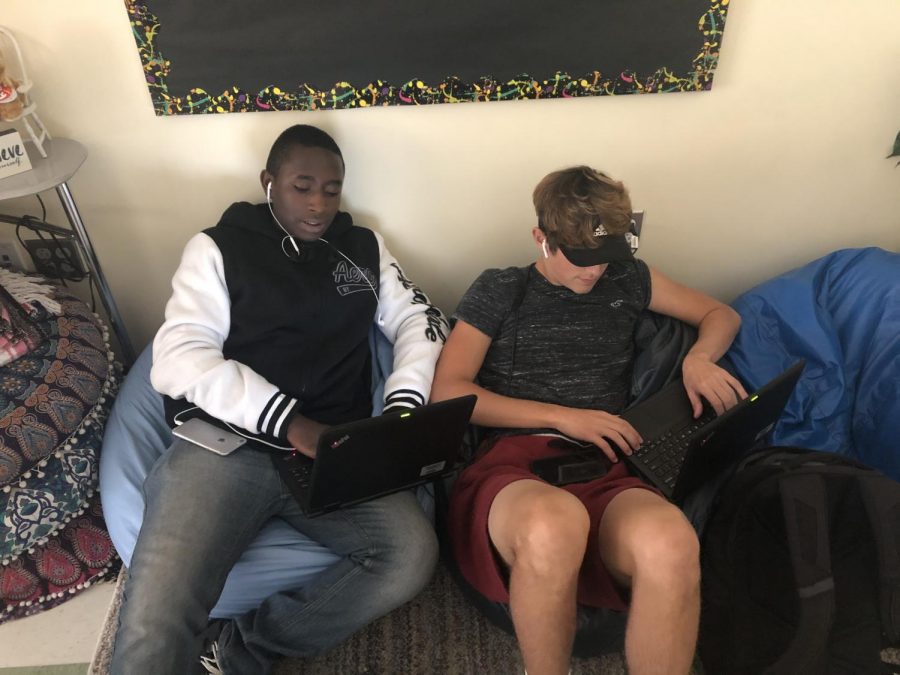 Sophomores Vincent Kariuki and Colby Trent scour online media for their Journalism/Media class at Abington High School on October 22, 2019.