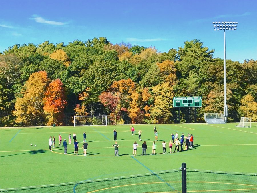 Students gather on the afternoon of Tuesday, October 15, 2019 on the field behind Abington High School.