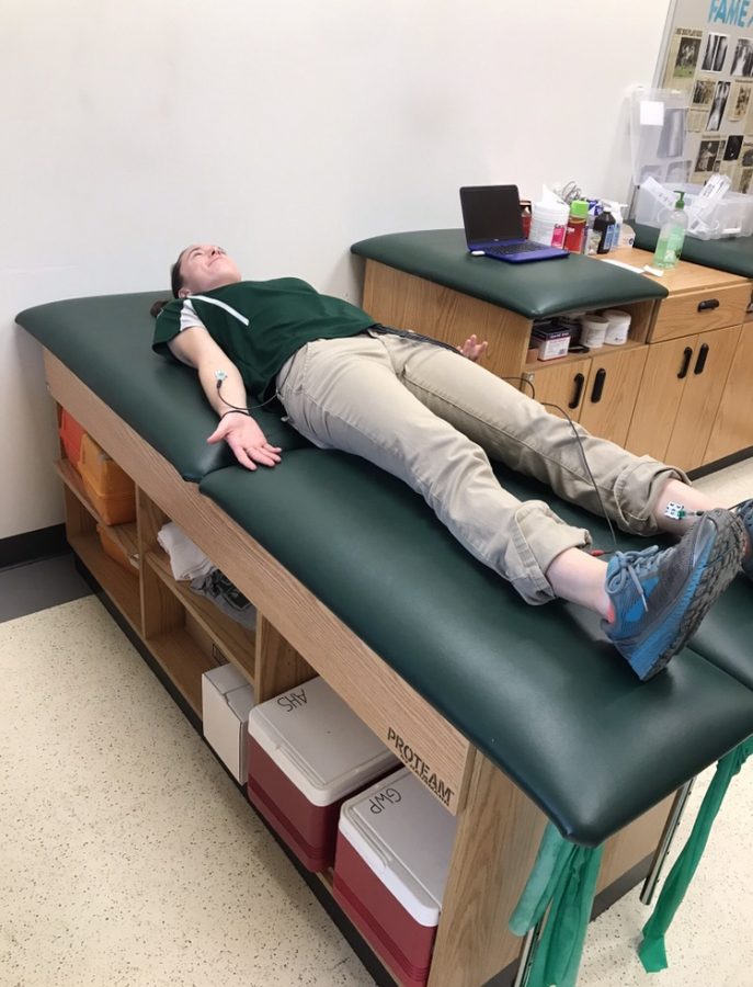 On October 8, 2019. Ms. Reid, Abington High Schools athletic trainer demonstrating how the ECG stickers are placed. 
