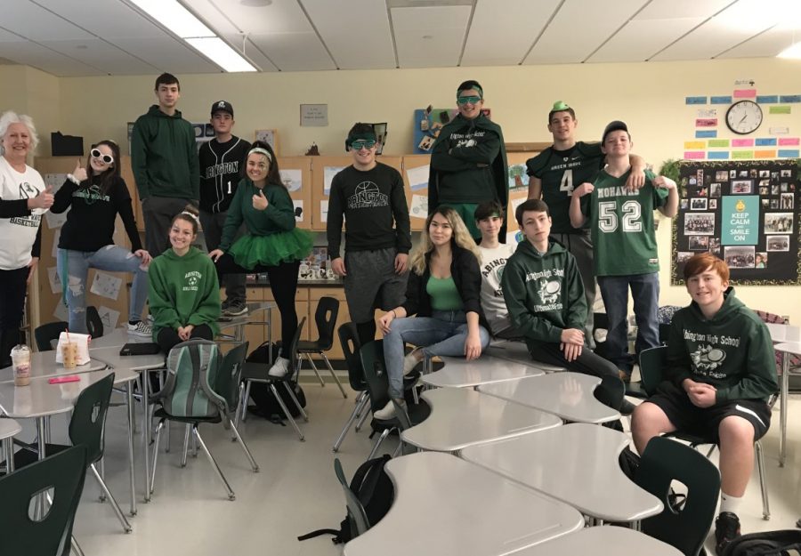 Seniors (and their teacher) show their colors on Wednesday morning before the Pep Rally on November 27, 2019, in Room 2215. Standing left to right: Ms. Pflaumer, Lexi McColgan, Johnny Hawkesworth, Ricky Reissfelder, Jess Rix, Andrew Roy, Connor Saccoach, Will Klein, and Charlie (Bubba) Gendreau. Sitting, left to right, Hannah Liebke, Kessya Nascimento, Drew Wilson, Declan Hamill, and Reid Norton.