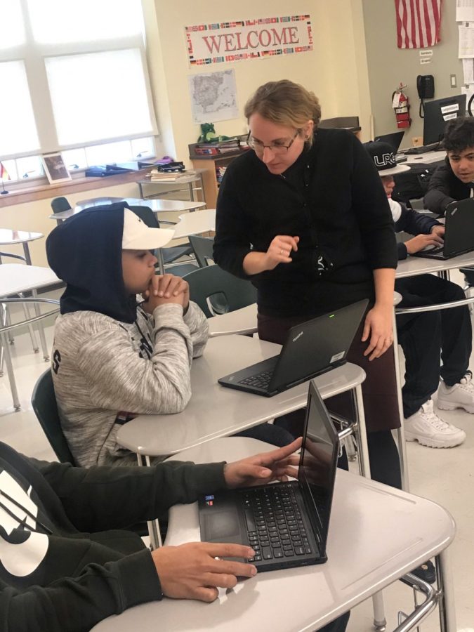Mrs. Despres, an English as a Second Language teacher at Abington High school, helps one of her students with his assignment during semester one.
