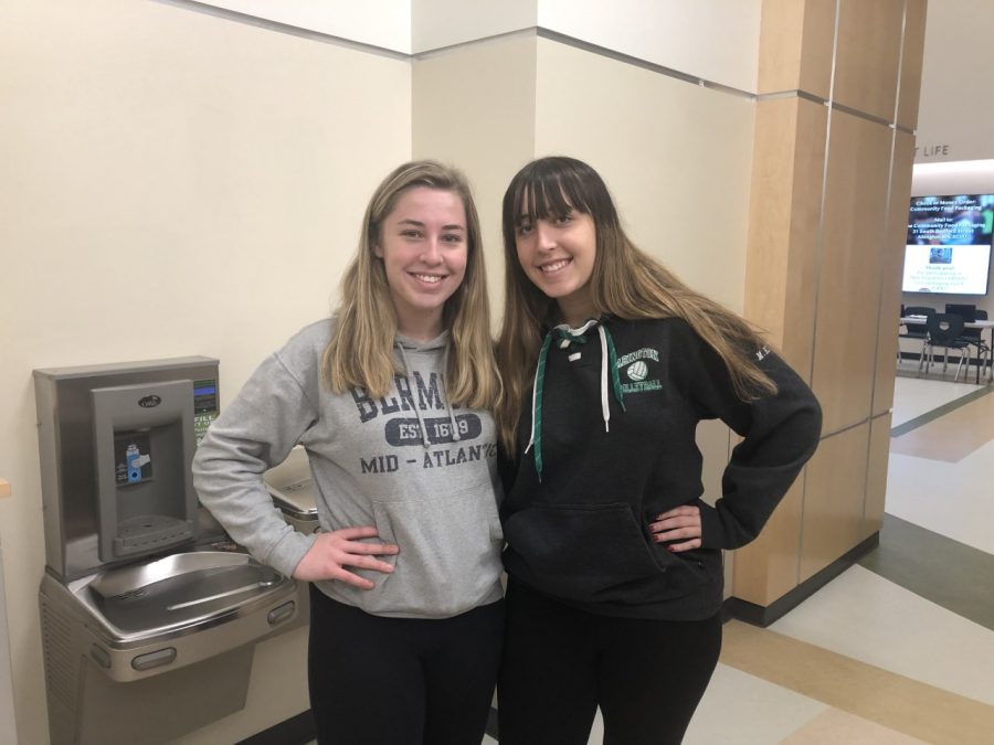 Abington High School senior twin sisters Ailey (left) and Manda Riddick (right) pose next to each other in the athletic hallway on Wednesday, December 11, 2019.