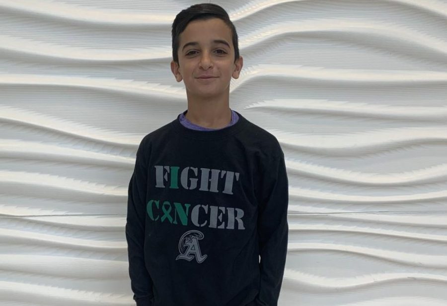 Freshman Joseph Hajjar of Abington High School wears a Blackout Cancer long sleeve T-shirt on Monday, January 13, 2020. T-shirts are being sold by SAAC and all proceeds will go to cancer research and helping those affected by the disease.