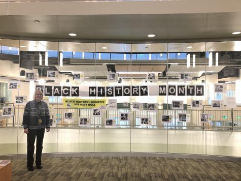 On Tuesday, February 11, 2020, Abington Middle-High School Library and Media Specialist Mrs. London stands inside the library. On the glass is the photo contest to celebrate Black History month.