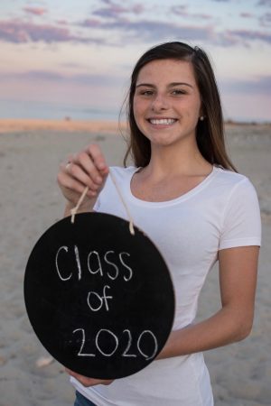 Senior Allison Clark of Abington High School poses for her senior portrait at Rexhame Beach in Marshfield, Massachusetts on August 1, 2019, unaware that her senior year attending school would be interrupted by the COVID-19 pandemic.