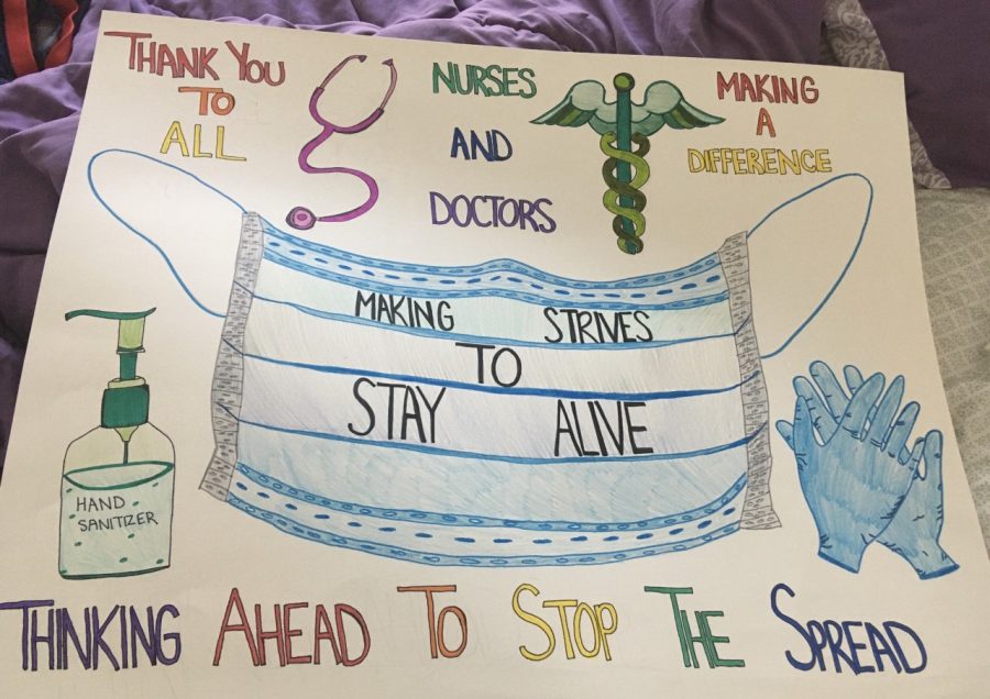 Abington High School senior Kayla Larkin is busy in the living room of her home making signs for first responders. This one “Thinking Ahead to Stop the Spread” was created on May 15, 2020.