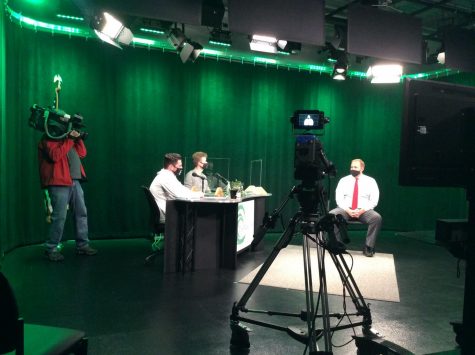 Chronicle TVs cameraman Scott takes some shots of the Green Wave Gazettes Digital Team Matthew Lyons (left) and Aaron Johnson (center) as they co-host their show The Weekly Wave on October 20, 2020, featuring Mr. Jonathan Bourn (right).