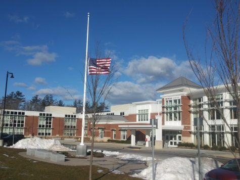 The United States flag in front of the Abington Middle-High School, waves at half-staff on February 25, 2021.