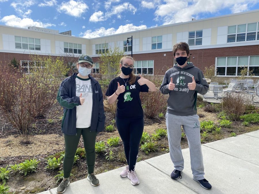 (left to right) sophomore Acadia Manley, and seniors Kathryn Genest and Brian Tolan show off their Green Wave Pride as they pose for a picture on a walk outside at Abington High School on April 30, 2021