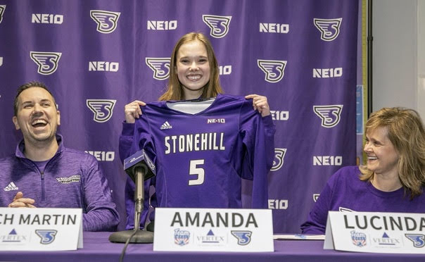 Amanda Murphy holding up her Stonehill College Volleyball jersey after signing a letter of intent on February 23, 2020, in the Merket Gymnasium. 